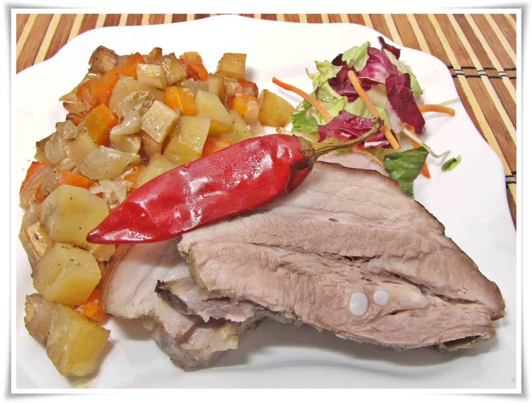 Fűszeres oldalas zöldséges krumpliágyon.